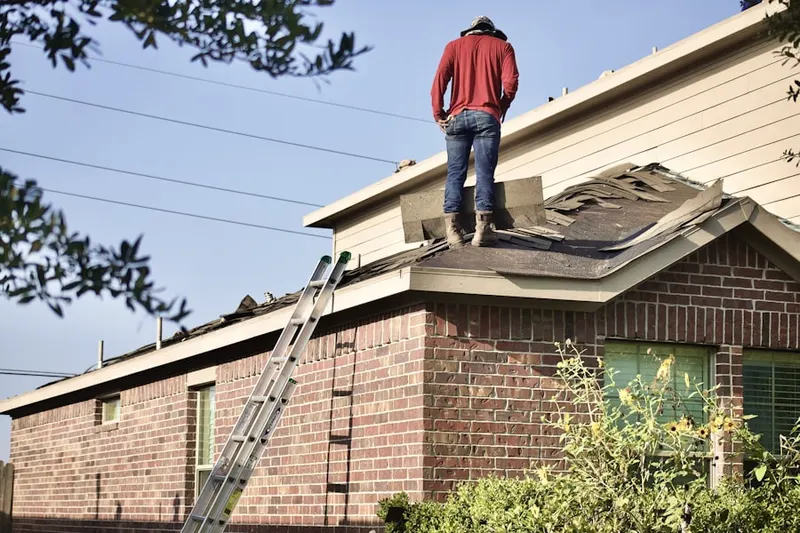 Professional roofer working on a residential roof in Geneva Road